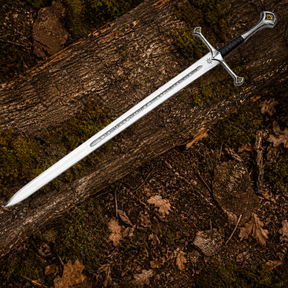 Full-length Anduril fantasy sword displayed diagonally across a mossy woodland log with engraved blade details visible