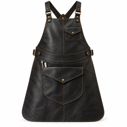Front view of Anvil Arc black cowhide blacksmith leather apron with two flap pockets, tan stitching and antique brass-finish buckles.