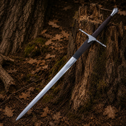 Braveheart William Wallace Longsword with polished silver blade leaning against an aged woodland tree stump