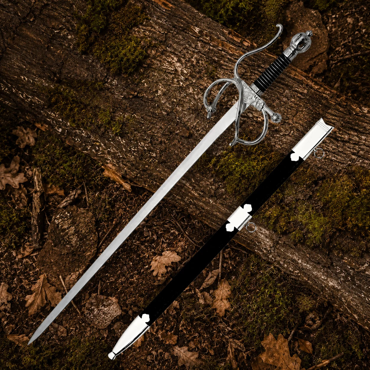 El Cid Rapier Sword with black scabbard and silver fittings arranged on moss-covered woodland logs