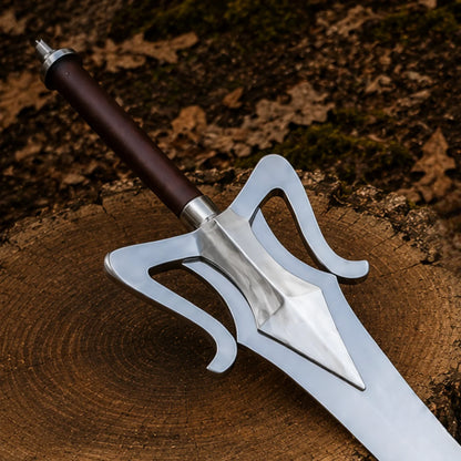 Close-up of the He-Man Power Sword dark wood-tone handle, steel pommel and sweeping open-work silver crossguard
