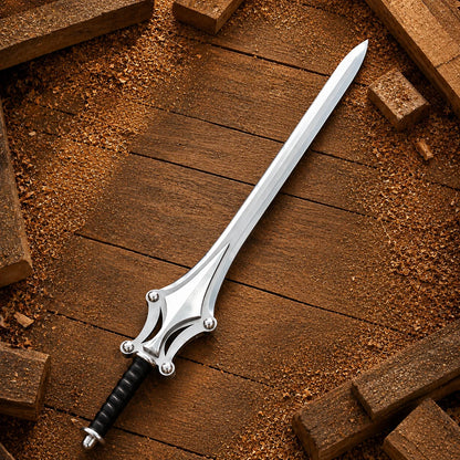 Full He-Man Power Sword displayed alone on timber showing silver blade, sculpted guard and black wrapped handle