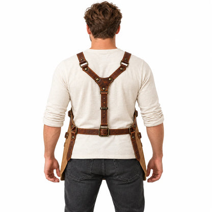 Back view of male model demonstrating the brown Y-back leather harness, adjustable waist buckle and side straps of the apron.