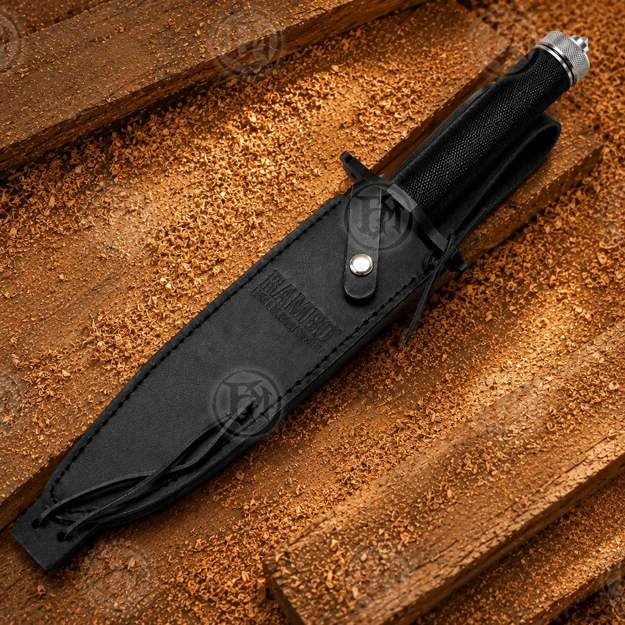 Black leather sheath enclosing the Rambo First Blood Part II knife with textured black handle visible above.