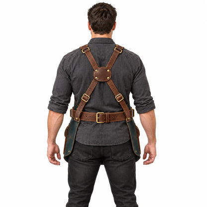Back view of male model demonstrating the Studio Wing apron's brown leather cross-back harness, adjustable buckles and waist belt.