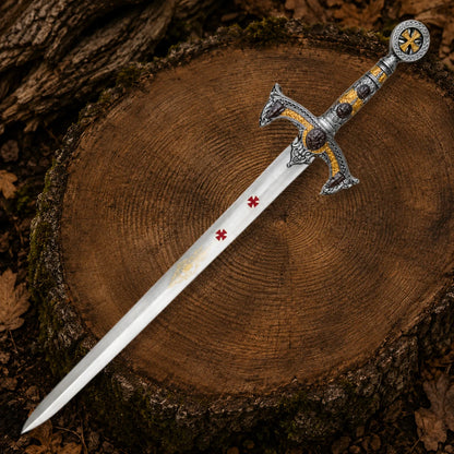 Full-length Templar Knights sword replica with red crosses, gold blade engraving and ornate medieval handle displayed on a tree stump